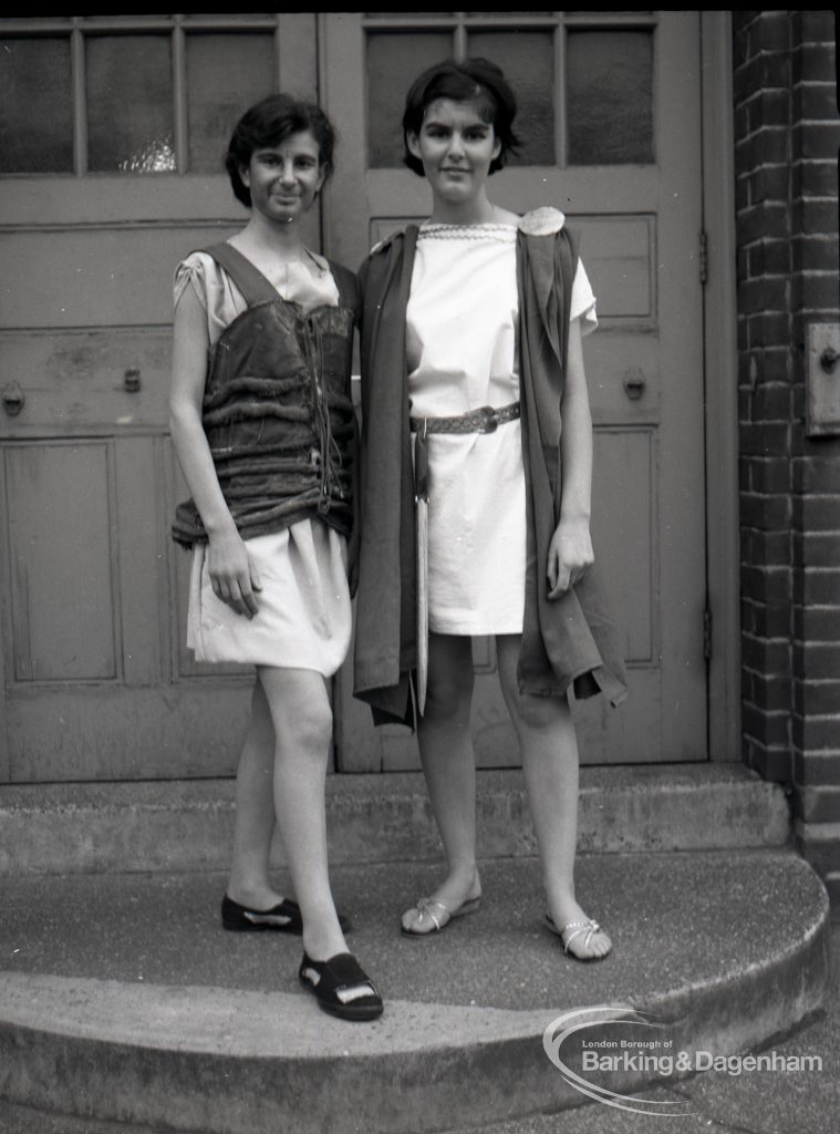 Dagenham Secondary school play, with children performing Androcles and the Lion, showing two members of cast on steps at school entrance, 1965