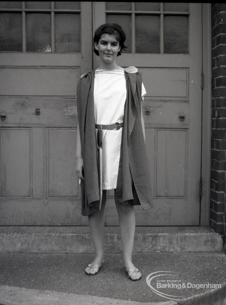 Dagenham Secondary school play, with children performing Androcles and the Lion, showing member of cast on steps at school entrance, 1965