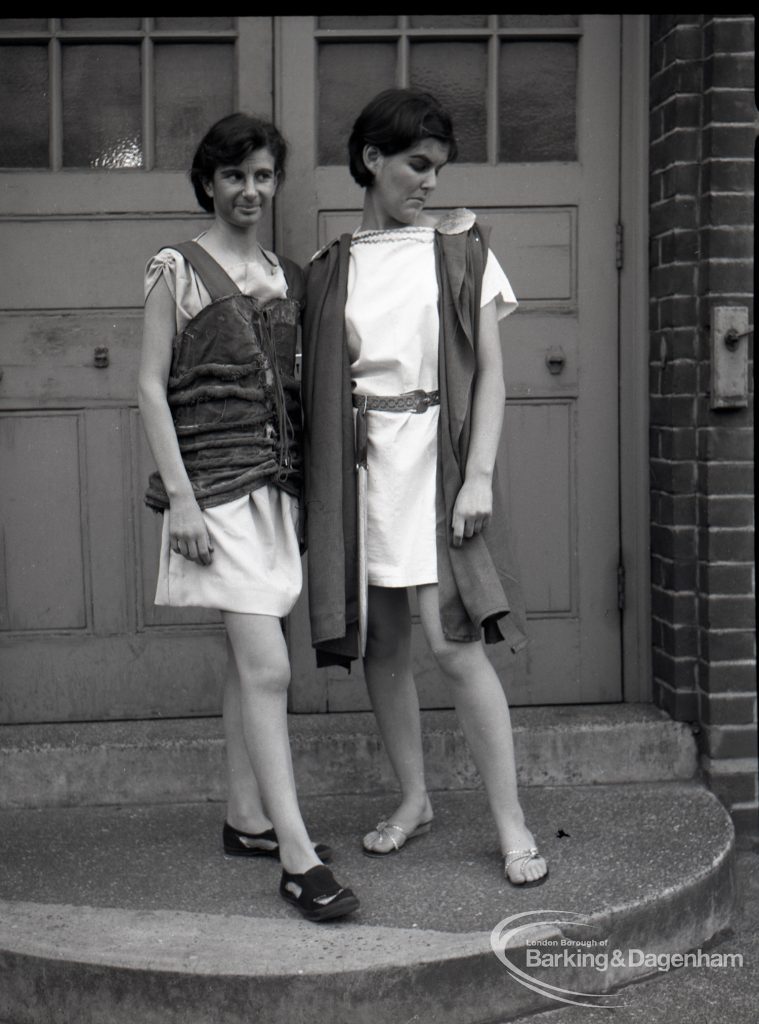 Dagenham Secondary school play, with children performing Androcles and the Lion, showing two members of cast on steps at school entrance, 1965