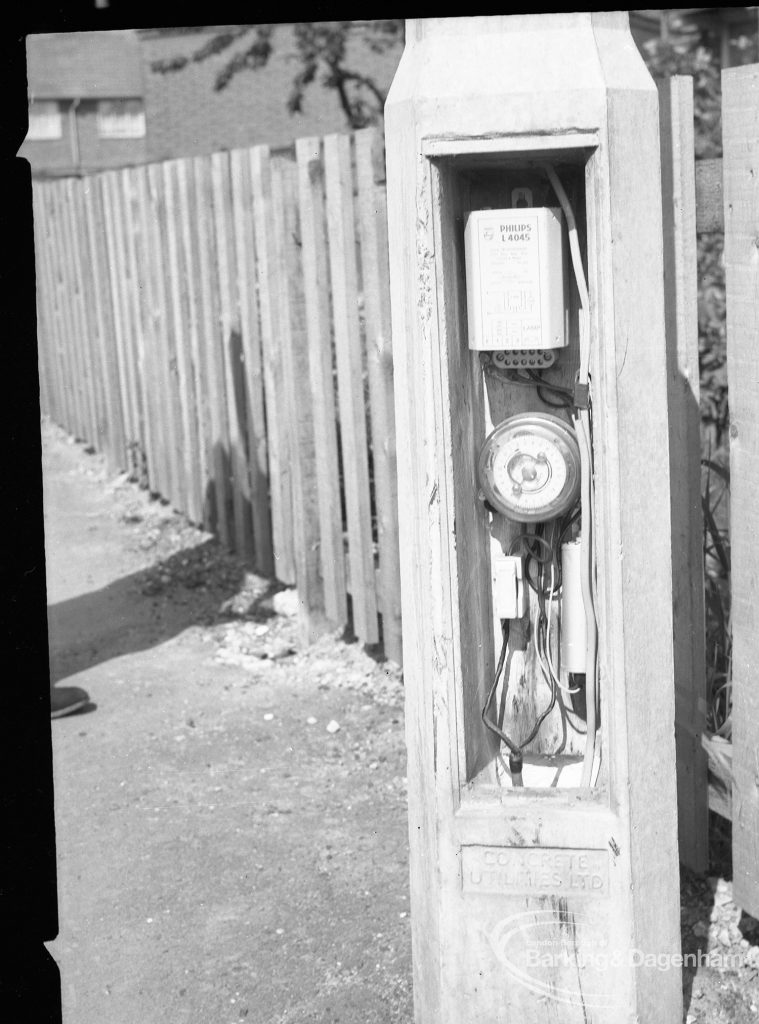 Dagenham street lighting, showing timer working in pillar, next to fence in Crescent Road, 1965
