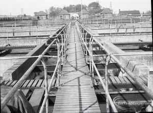 Riverside Sewage Works Reconstruction V, showing catwalk between the sludge tanks, 1965