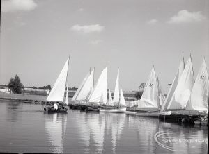 Boating at Mayesbrook Park, Dagenham, showing side view of nine moored sailing yachts at landing stage, 1965