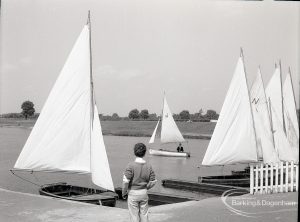 Boating at Mayesbrook Park, Dagenham, showing boy and moored yachts, 1965