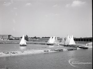 Boating at Mayesbrook Park, Dagenham, showing distance view of landing stage and yachts, with one yacht sailing away, 1965