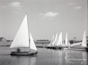 Boating at Mayesbrook Park, Dagenham, showing sailing yacht approaching landing stage, 1965