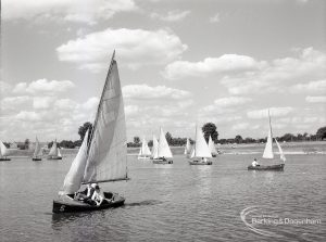 Boating at Mayesbrook Park, Dagenham, showing one parked yacht, and others sailing, 1965