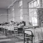 Health education, showing south side of Dagenham Hospital lower ward, with two nurses and patients, 1965