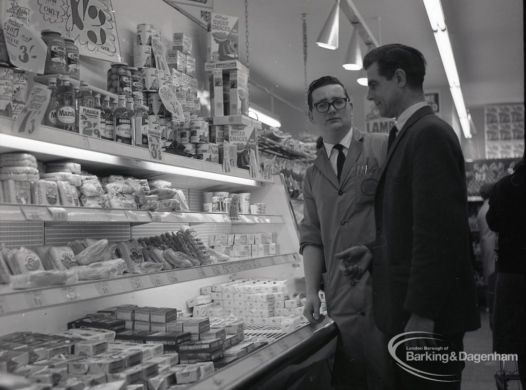 Health education, showing Inspector with Manager by refrigerated food shelves at Wallis Supermarket, Rush Green, 1965