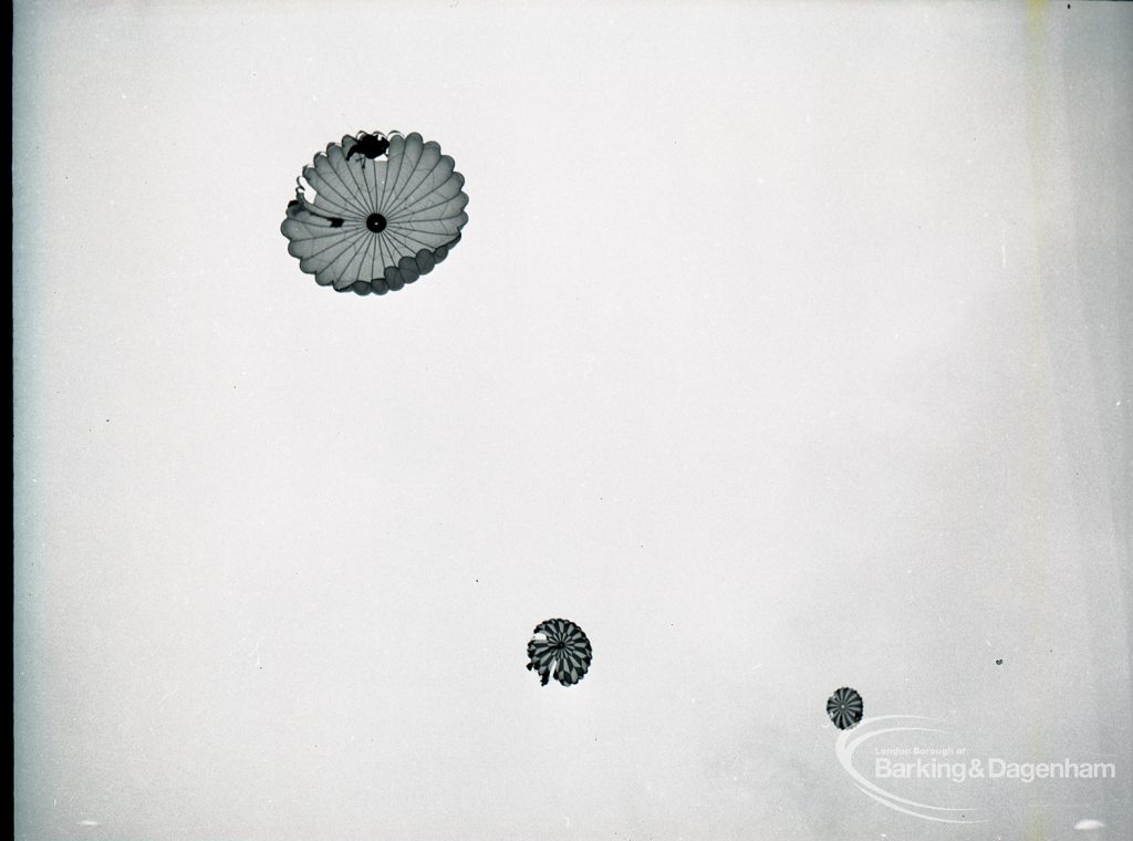 Dagenham Town Show 1965, showing a free fall parachute display by members of the Green Jackets Brigade, with three parachutists in the air, 1965