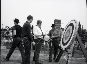 Dagenham Town Show 1965, showing archers extracting arrows from target during archery display, 1965