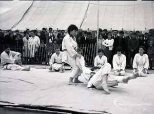 Dagenham Town Show 1965, showing judo demonstration fall with person floored and legs towards camera, and three people kneeling, 1965