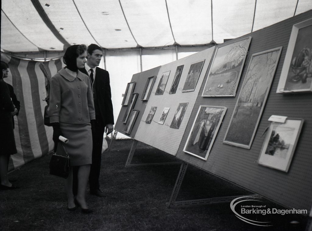 Dagenham Town Show 1965, showing pictures in art exhibition and two visitors, 1965