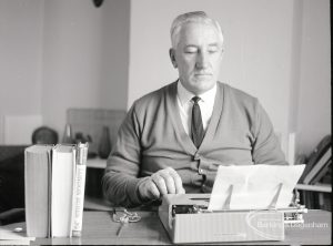 Mr Ted Murphy, 3 Raydons Road, Dagenham, full face photograph and typing, and with books standing to left, author of ?The Big Load? and ?London Buses?, photographed for ?Barking Record?, 1965