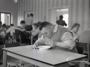 Adult Training College at Osborne Square showing a boy bending over table at lunch time, 1965