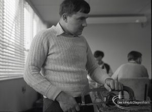 Adult Training College at Osborne Square showing a boy working at cutting machine in the metal workshop, 1965