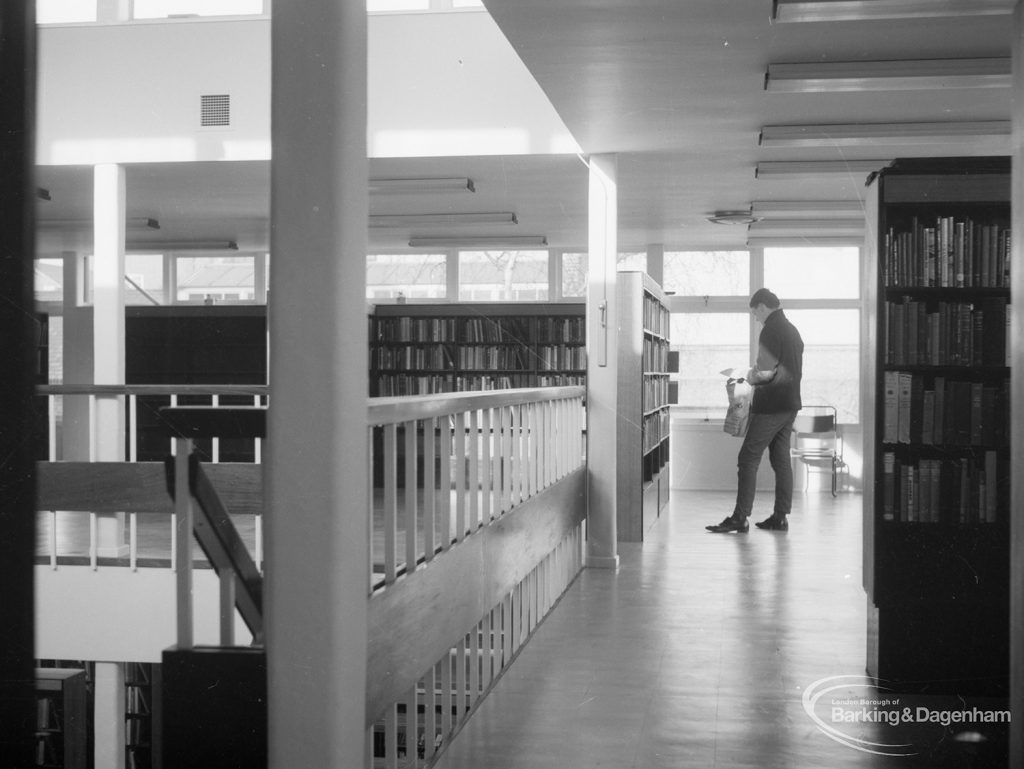 New Barking Library Lending Department, showing youth standing by stock on first floor, 1965