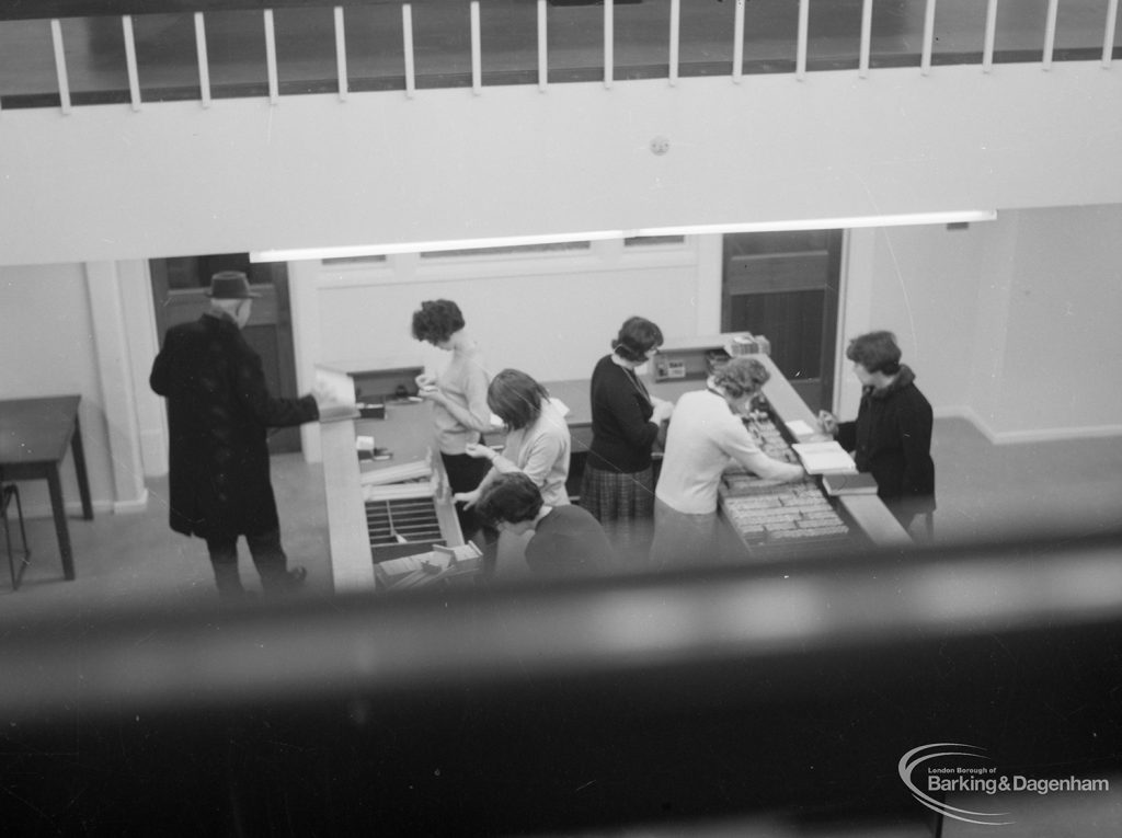 New Barking Library Lending Department, showing counter with five members of staff and reader, taken from gallery, 1965