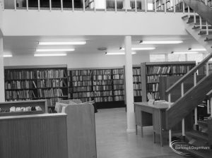 New Barking Library Lending Department, showing view across ground floor, with counter, desk, bookshelves and staircase, 1965