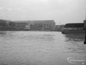 Barking Creek, showing warehouses and covered boat from centre of quay, 1966