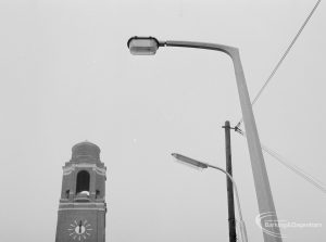 Lighting with specially erected sample lamp-posts at Barking, showing two lanterns and Barking Town Hall clock tower, 1966