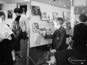 Barking Libraries exhibition at Valence House, Dagenham for National Book Week, showing boy looking at astronomy book on display stand, 1966