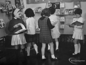 Barking Libraries exhibition at Valence House, Dagenham for National Book Week, showing five girls examining books in the astronomy section, 1966