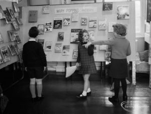 Barking Libraries exhibition at Valence House, Dagenham for National Book Week, showing children looking at the ‘Mary Poppins Presents’ display stand, 1966