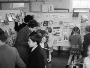 Barking Libraries exhibition at Valence House, Dagenham for National Book Week, showing a group of children and parents enjoying the ‘Mary Poppins Presents’ display, 1966