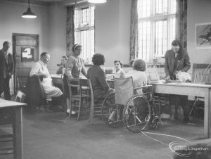 Training Centre at Eastbury House, Barking, showing seven people around table, at work making baskets, 1966