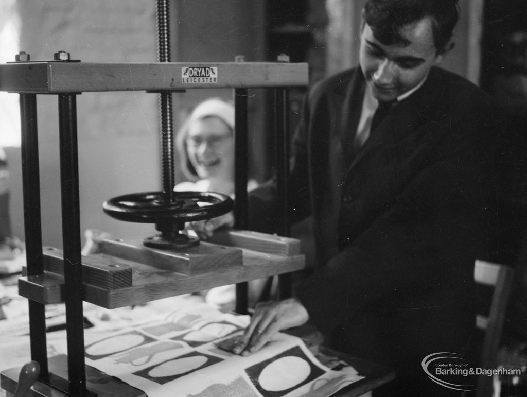 Training Centre at Eastbury House, Barking, showing man at press, with laughing woman behind, 1966