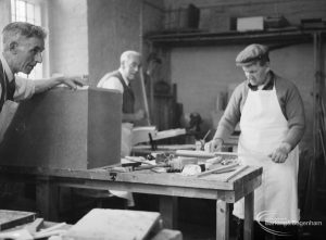 Training Centre at Eastbury House, Barking, showing men doing woodwork, with three at a workbench, one in overalls, 1966