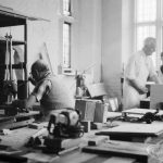 Training Centre at Eastbury House, Barking, showing men doing woodwork, with one man seated and drilling holes, and two men at bench, 1966