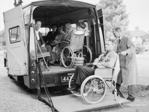 Training Centre at Eastbury House, Barking, showing wheelchair user on ambulance tail-lift, leaving after event, 1966