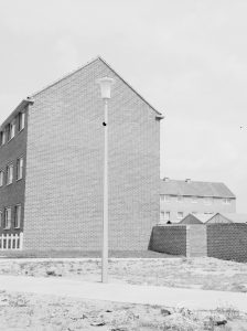 The side of a block of flats [possibly in Barking or Dagenham] and an aluminium lamp-post, 1966