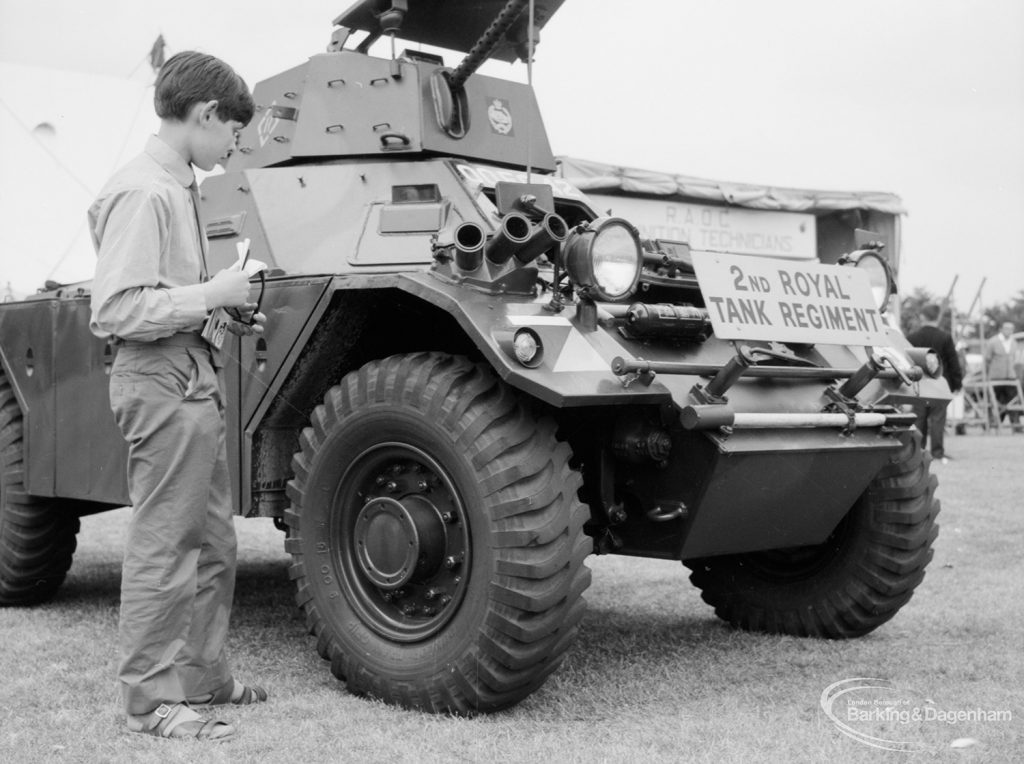 Dagenham Town Show 1966, showing a visitor standing next to a tank in the Second Royal Tank Regiment, 1966