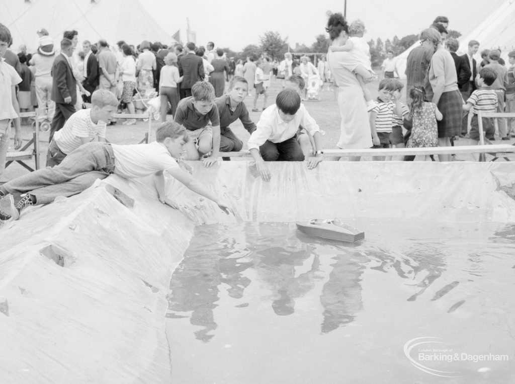 Dagenham Town Show 1966, showing boys looking at boats in the Mayesbrook Model Boat Society pool, 1966