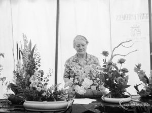 Dagenham Town Show 1966 at Central Park, showing Mrs Lynch with Flower Arrangement Society Alpine exhibit in Visual Arts display, 1966