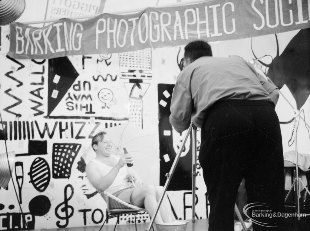 Dagenham Town Show 1966 at Central Park, showing Barking Photographic Society display, with photographer at work during photographic session, 1966