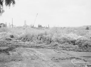 Riverside Sewage Works Reconstruction XII, showing panoramic view of undeveloped area, with rough dirt tracks amongst wild flowers and with industrial buildings on horizon [sequence running from left to right EES11459 – 60 – 66 – 65 – 62 – 67 – 63 – 64 – EES11461], 1966