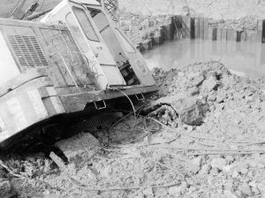 Riverside Sewage Works Reconstruction, showing Hadsphaltic digger submerged in mud in creek, 1966