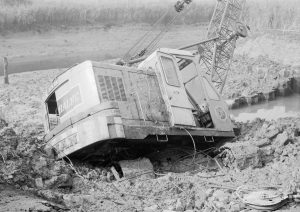 Riverside Sewage Works Reconstruction, showing Hadsphaltic digger submerged in mud in creek, seen from landward side, 1966