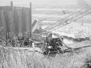 Riverside Sewage Works Reconstruction, showing Hadsphaltic digger submerged in clay, seen from grass bank above, and with crane’s rig to right, 1966