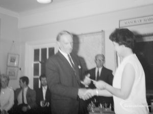 Retirement ceremony for Deputy Borough Librarian W C Pugsley,  showing him receiving leaving gift from Libraries Chairman Councillor Mrs Thomas, 1966