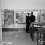 Barking Abbey 1300th anniversary exhibition at Barking Central Library, showing two visitors in central area and drawing of Abbey on left, 1966