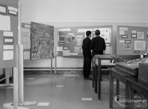 Barking Abbey 1300th anniversary exhibition at Barking Central Library, showing two visitors in central area and drawing of Abbey on left, 1966