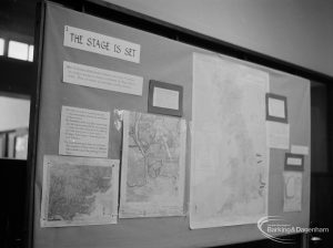 Barking Abbey 1300th anniversary exhibition at Barking Central Library, showing ‘The Stage is Set’ stand displaying maps, 1966