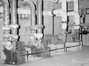 Heating, showing mounted circulating pumps and tagged water pipes at Heath Park substation, 1966