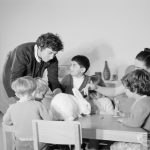Health, showing rebuilt Ashton Road Clinic, Chadwell Heath, with four children at play in Nursery with white rabbit and two attendants, 1966