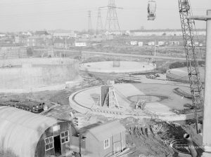 Riverside Sewage Works Reconstruction XIV, showing several circular saucers and workmen’s huts, viewed from above, 1966