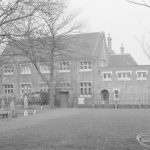 Barking Church of England School, later known as St. Margaret’s Church of England School, Back Lane, Barking, showing the main school building with Barking Abbey burial site in foreground, 1967